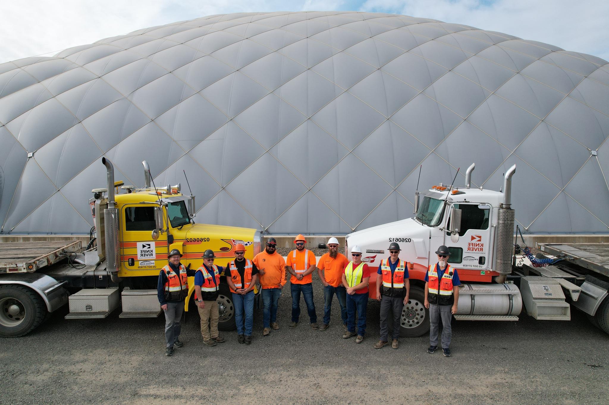 Photo of CDL students and their trucks